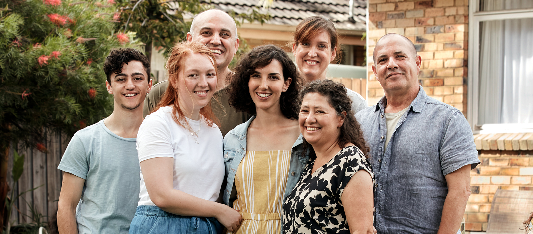 Supportive family gathered around LGBTIQ+ couple