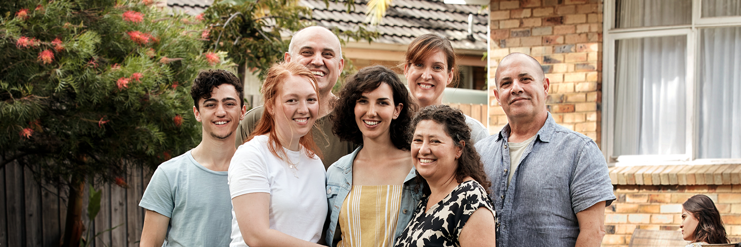 Supportive family gathered around LGBTIQ+ couple