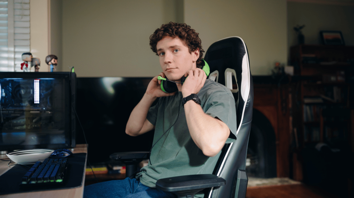 Ben, a What Kind of Man Do You Want to Be participant, sits at his computer, putting on gaming headphones.