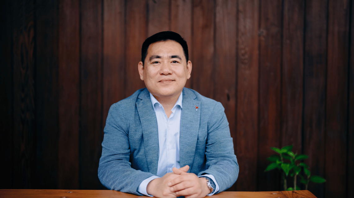 Portrait of a man in a blue jacket.