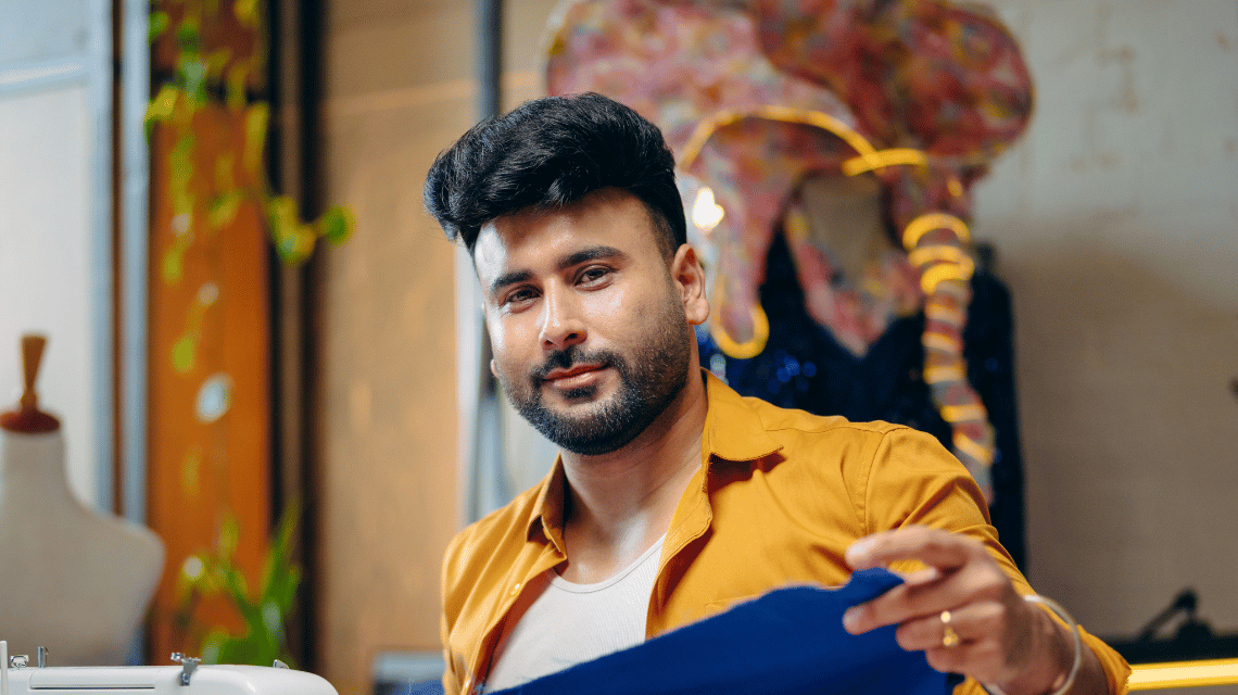 Portrait of a man working in a sewing studio.