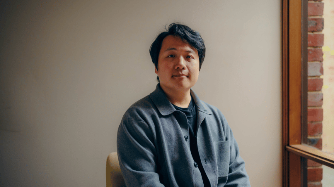 Portrait of a man in a blue shirt.